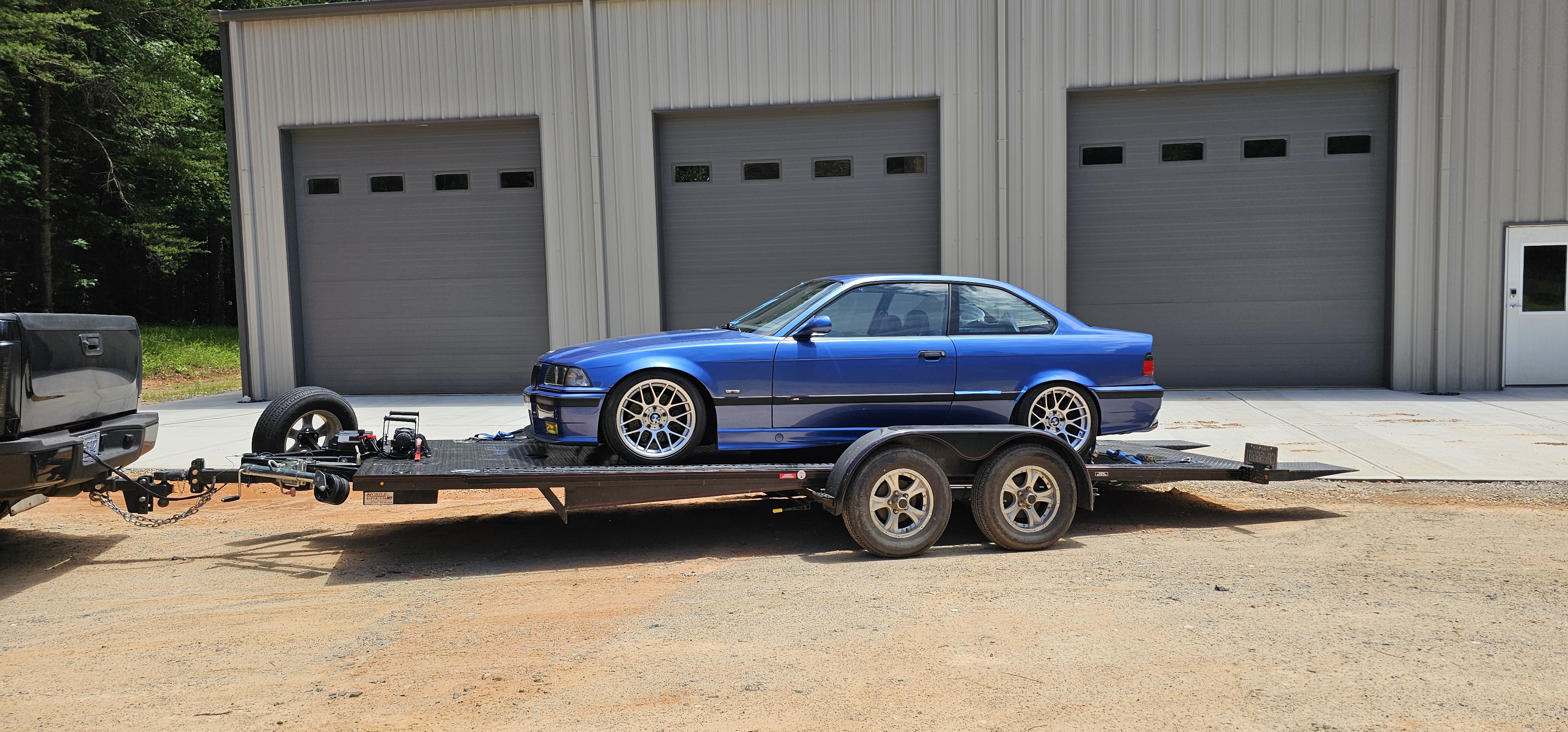 Professional car hauler trailer rental in Denver NC - carrying blue vehicle